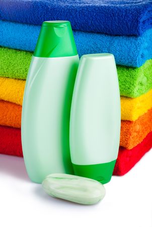 Colour terry towels combined by pile, toilet soap and two bottles with shampoo on white background. Isolated.
の写真素材