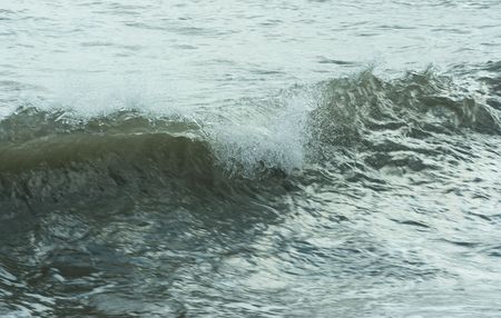 The twirled sea wave approaching on coast