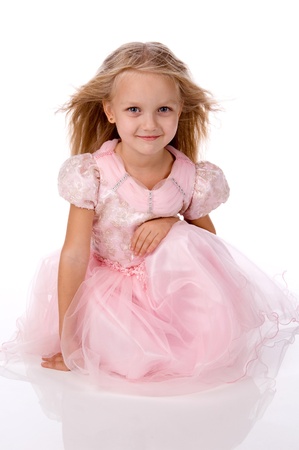 little girl in a pink elegant dress.White backgroundの写真素材