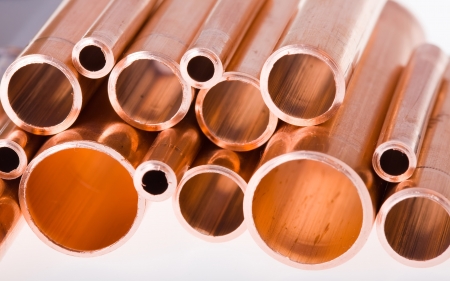 Set of copper pipes of different diameter lying in one heapの写真素材