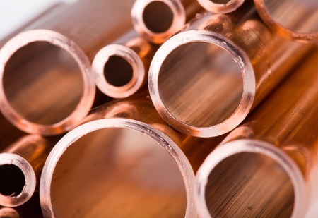 Set of copper pipes of different diameter lying in one heapの写真素材