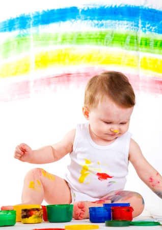 little girl bedaubed with bright colorsの写真素材