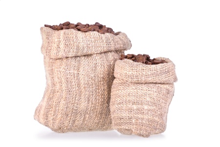 Coffee beans in canvas sack isolated on whiteの写真素材