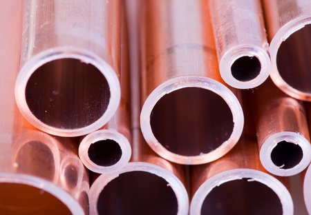 Set of copper pipes of different diameter lying in one heapの写真素材