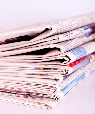 Set of old newspapers combined by a pile