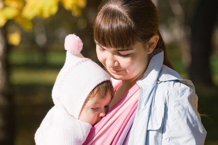 Walk with the child in a baby sling. Breastfeedingの写真素材