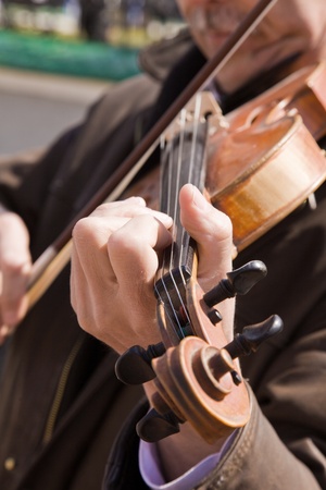 The man plays a violin. Hands of the musician close up.の写真素材