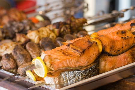 Barbecue prepared from salmon fish with a lemon and vegetablesの写真素材