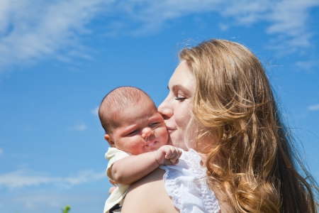 happy young woman holds the newborn childの写真素材