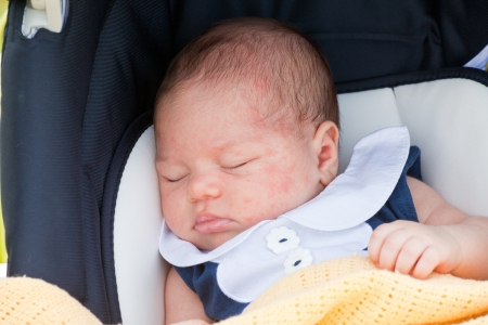Small child sleeps in an automobile chair. Concept of safety of trafficの写真素材