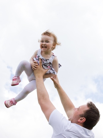 father and daughter under blue skyの写真素材
