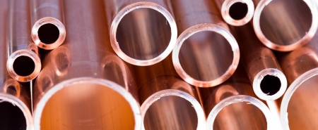 Set of copper pipes of different diameter lying in one heapの写真素材