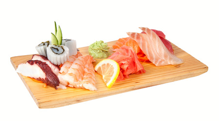 Sashimi set of octopus, squid, shrimps, tuna and rudderfish with wasabi and lemonの写真素材