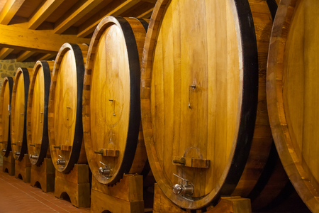 cellar with barrels for storage of wine, Italy