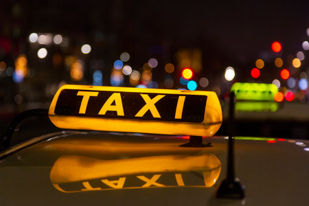 taxi on a city street at nightの写真素材