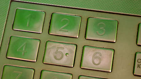 Metal ATM keyboard buttons. Green ATM.