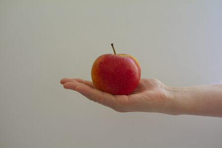 the girl holds ripe red juicy appleの写真素材