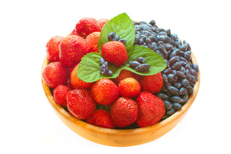 strawberries and honeysuckle and mint leaves isolated on whiteの写真素材