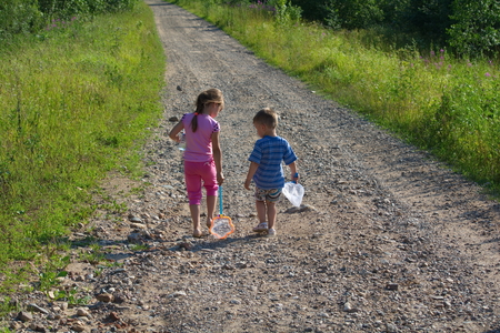 small children go on a rural roadの写真素材