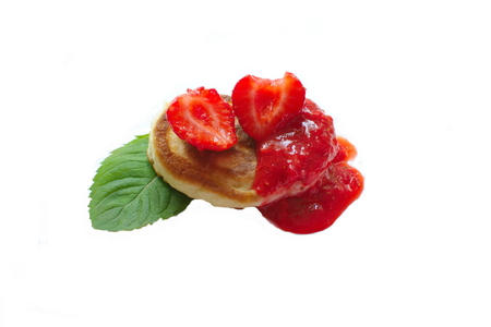 pancakes with strawberry jam with whole berries with mintの写真素材