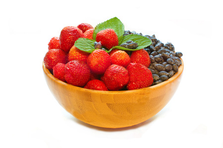 strawberries and honeysuckle and mint leaves isolated on whiteの写真素材