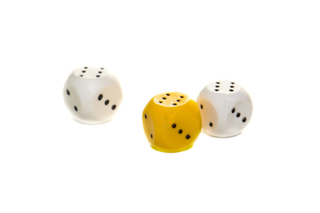 white and yellow dice isolated on white backgroundの写真素材
