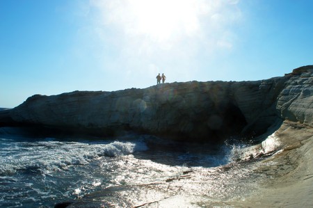 couple in love on the high seashore in backlight sunlightの写真素材