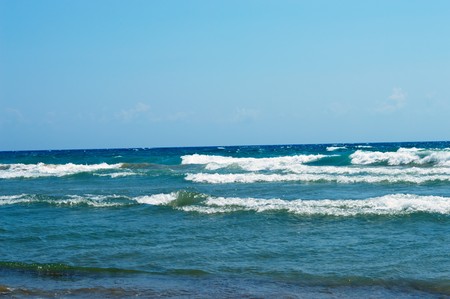 seascape ashore from the rolling blue wavesの写真素材