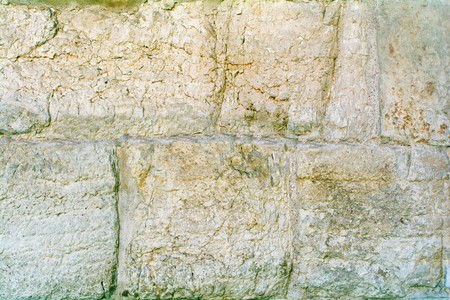 background of ancient wall made of blocks of sandstoneの写真素材