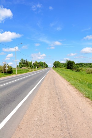 the paved highway and the surrounding rural landscapeの写真素材