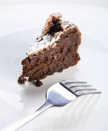Slice of flourless chocolate cake with forkの写真素材
