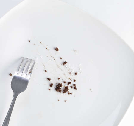 Empty plate with leftover cake crumbsの写真素材