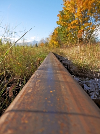 The rail in the detailed photo shows autumn direction hiking the mountains.の写真素材