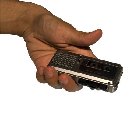 A male hand holding a microcassette recorderの写真素材