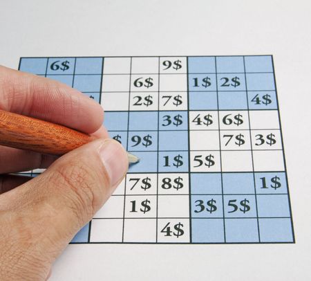 Male man playing sudoku with dollars symbol in itの写真素材