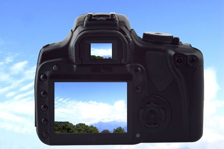 A black reflex photocamera shooting landscape of blue sky with clouds, same image on live view and viewfinderの写真素材