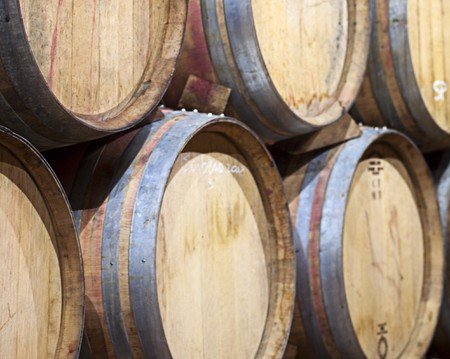 Closeup of wine barrels piled in a cellar