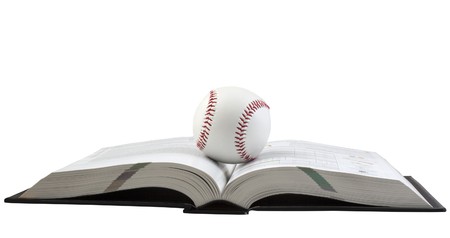 Ball for baseball over an open book, on white backgroundの写真素材