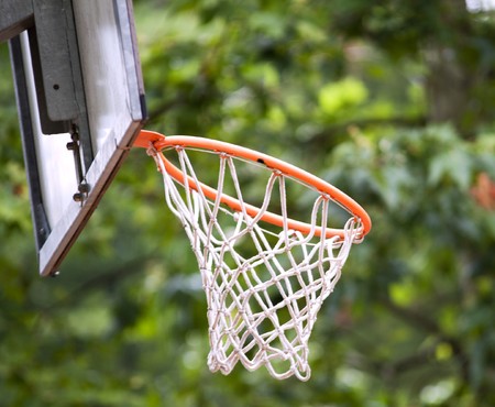 An inclined basket of a playground, over green leaves background
