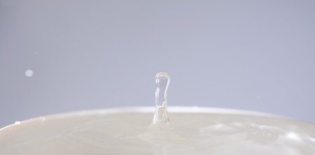 Lonely drop coming out from a can full of waterの写真素材