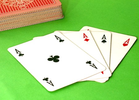 Four aces on the table, green background