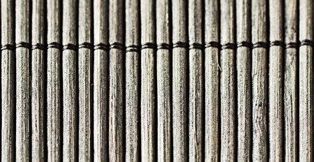 Background of a closeup of a little black wooden matの写真素材