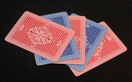 Covered red and blue playing cards over black