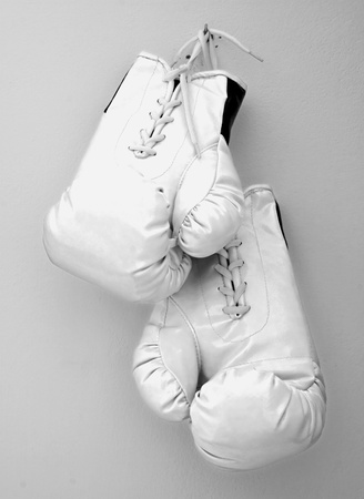 White boxe gloves pending from a nail on a wallの写真素材