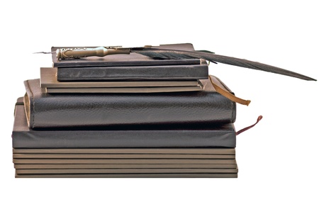 Stack of books and notebooks with old pen の写真素材