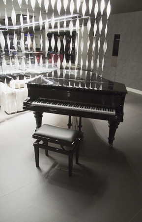 Beautiful black piano near a light decorationの写真素材