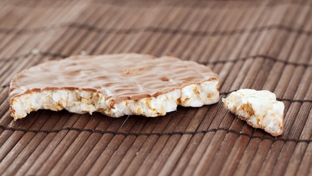 Broken sweet cookie of rice over wooden mat