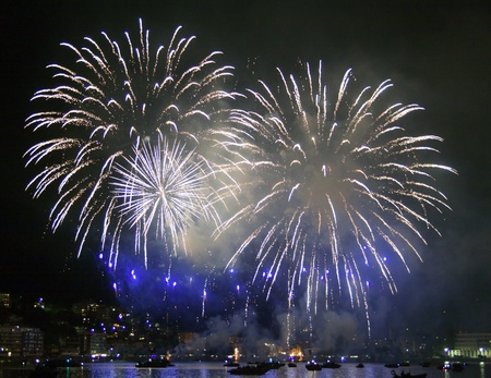 Great fireworks exploding over the waters of a lakeの写真素材