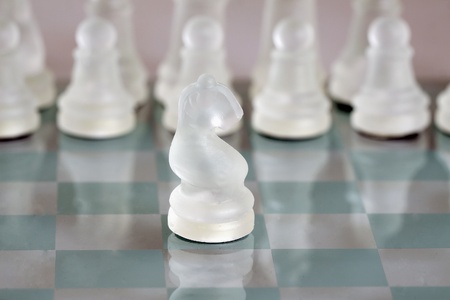 Glass horse of chess on a chessboardの写真素材