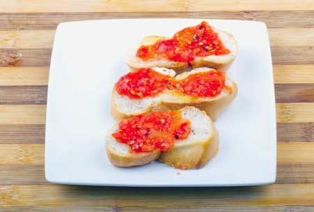 Typical italian appetizer  bruschette  with tomato over white plateの写真素材